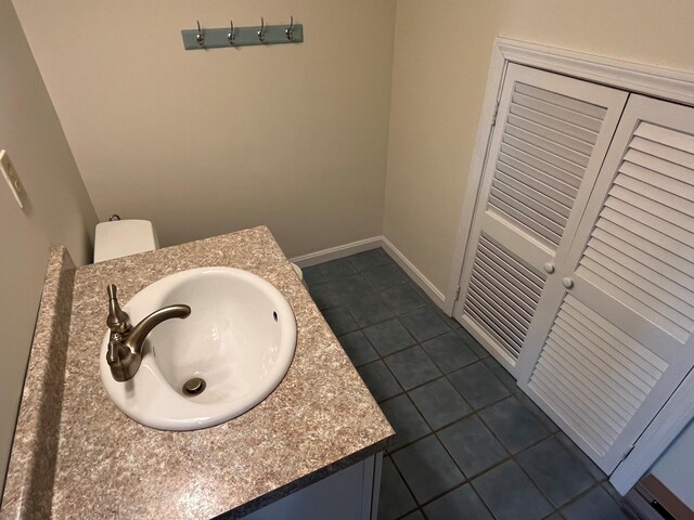 bathroom featuring vanity, tile patterned floors, and baseboards