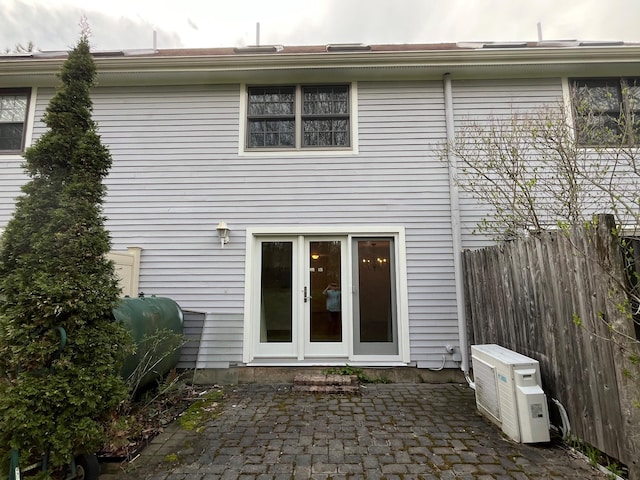 back of property with a patio, fence, oil tank, and ac unit