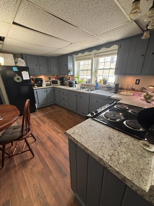 623 Gore Rd, Otisfield, ME 04270 - kitchen featuring gray cabinets, freestanding refrigerator, a paneled ceiling, a sink, and dark wood finished floors