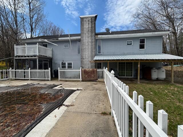 623 Gore Rd, Otisfield, ME 04270 - rear view of house with a chimney