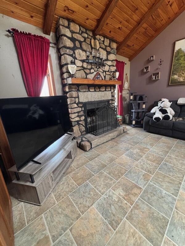 623 Gore Rd, Otisfield, ME 04270 - living room with wood ceiling, stone tile flooring, and a fireplace