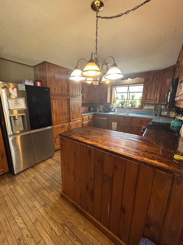 623 Gore Rd, Otisfield, ME 04270 - kitchen with stainless steel fridge, wood counters, light wood-style flooring, black microwave, and a chandelier