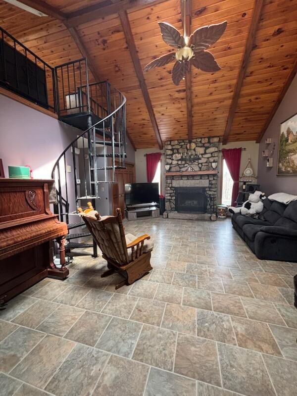 623 Gore Rd, Otisfield, ME 04270 - living room featuring wooden ceiling, stone tile floors, stairway, ceiling fan, and beamed ceiling