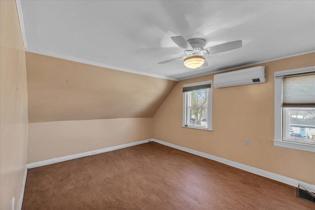 bonus room with a wall unit AC, healthy amount of natural light, baseboards, and vaulted ceiling