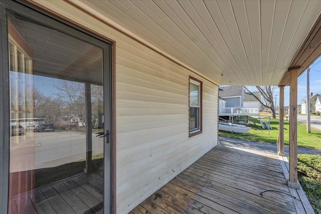 wooden terrace featuring covered porch