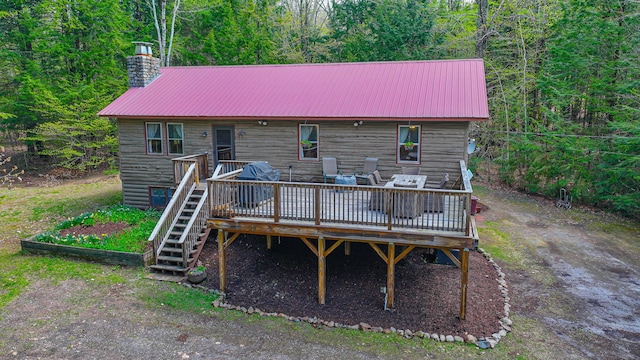 124 Alpine Village Rd, Harrison, ME 04040 - back of property featuring a chimney, metal roof, a deck, and stairway