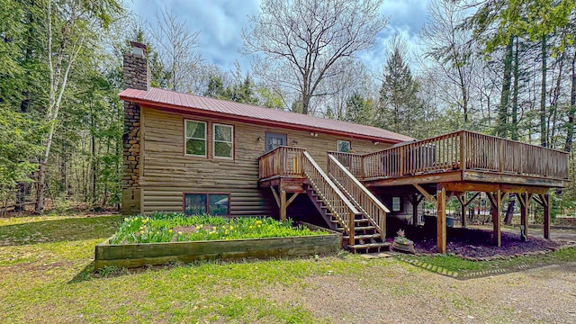 124 Alpine Village Rd, Harrison, ME 04040 - back of house with stairs, a chimney, a wooden deck, metal roof, and log siding