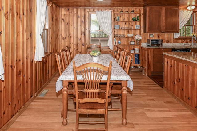 124 Alpine Village Rd, Harrison, ME 04040 - dining space with light wood-style floors and wood walls