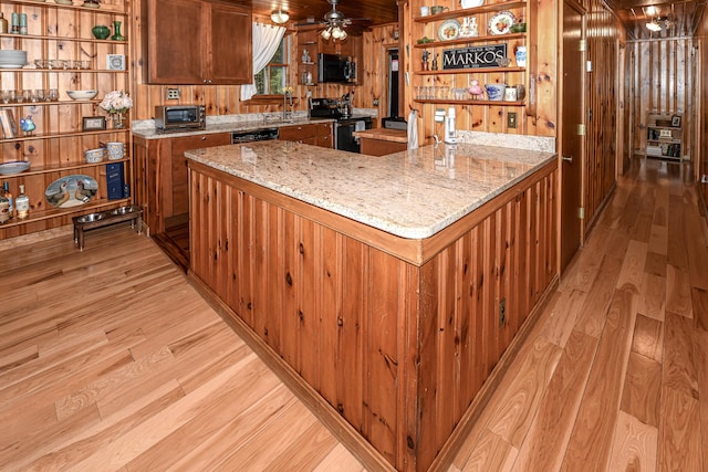 124 Alpine Village Rd, Harrison, ME 04040 - kitchen with light wood-style floors, stainless steel microwave, open shelves, a peninsula, and wood walls