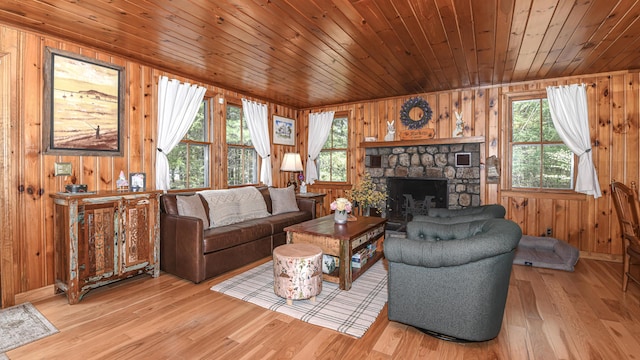 124 Alpine Village Rd, Harrison, ME 04040 - living area with wooden walls, healthy amount of natural light, wooden ceiling, light wood-style floors, and a fireplace