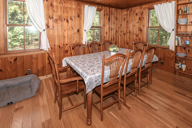 124 Alpine Village Rd, Harrison, ME 04040 - dining space with wood walls, light wood-style floors, and wooden ceiling