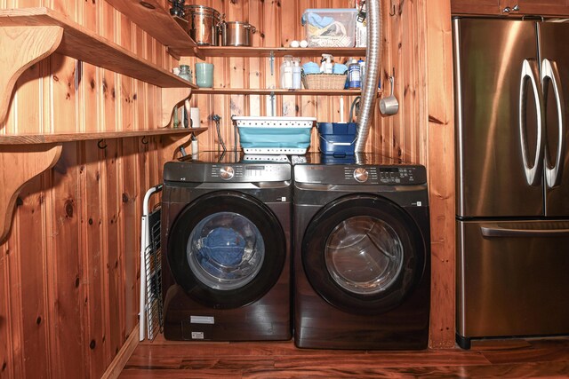 124 Alpine Village Rd, Harrison, ME 04040 - clothes washing area with washer and clothes dryer, wooden walls, and wood finished floors