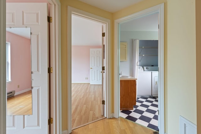 30 Glenridge Dr Unit 30, Portland, ME 04102 - hallway with a baseboard heating unit, independent washer and dryer, and light floors