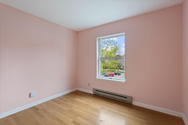 30 Glenridge Dr Unit 30, Portland, ME 04102 - unfurnished room featuring a baseboard heating unit, light wood-style flooring, and baseboards