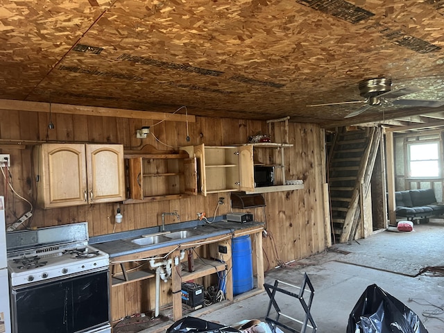 173 Ham Dr, Springfield, ME 04487 - kitchen with range with gas stovetop, open shelves, ceiling fan, wood walls, and a sink