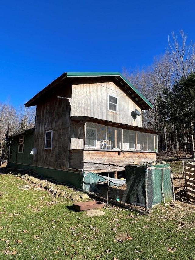 173 Ham Dr, Springfield, ME 04487 - view of side of home with a sunroom and a yard