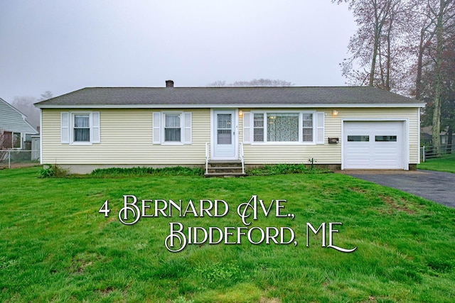 view of front of house with an attached garage, entry steps, and asphalt driveway