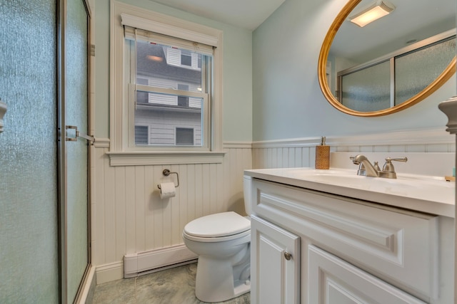 4 Union Ave, Old Orchard Beach, ME 04064 - full bath with baseboard heating, a stall shower, vanity, toilet, and a wainscoted wall