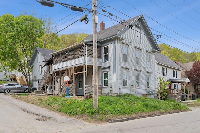 14 N St, Augusta, ME 04330 - view of front of home featuring a chimney, a sunroom, and a shingled roof