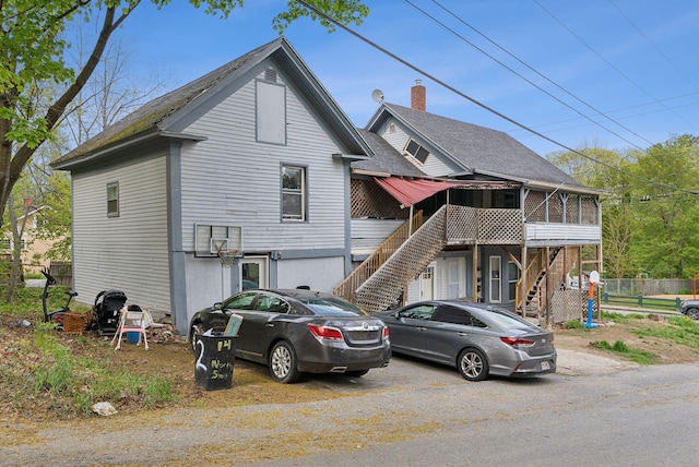 14 N St, Augusta, ME 04330 - view of front facade with stairway, a sunroom, and roof with shingles