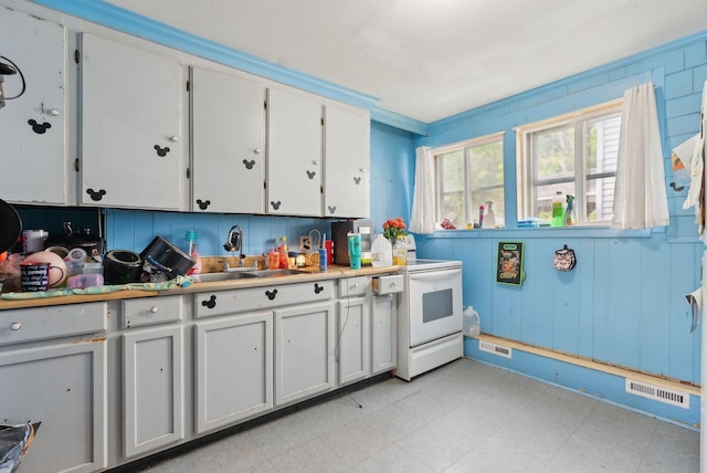 14 N St, Augusta, ME 04330 - kitchen featuring a sink, light floors, white electric range oven, light countertops, and white cabinetry
