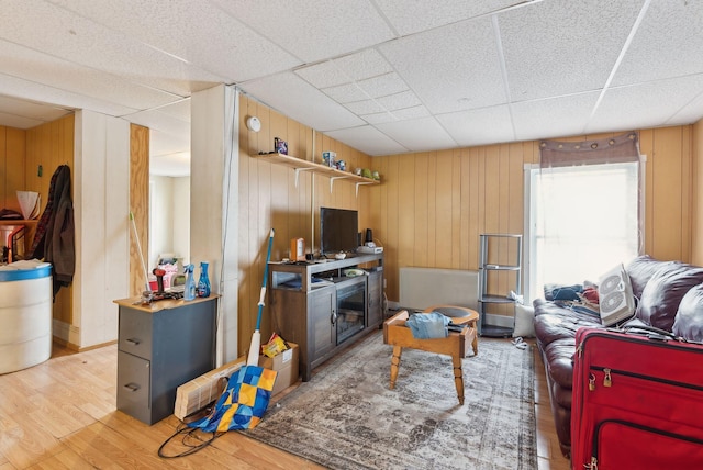 14 N St, Augusta, ME 04330 - living area with light wood-style floors, wooden walls, and a drop ceiling