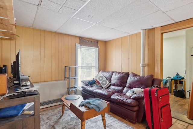 14 N St, Augusta, ME 04330 - living room with a drop ceiling, wood finished floors, a baseboard radiator, and wooden walls