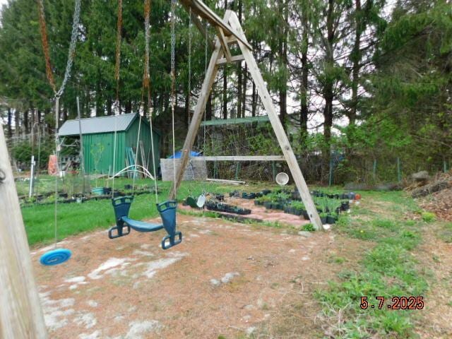 view of playground featuring an outbuilding
