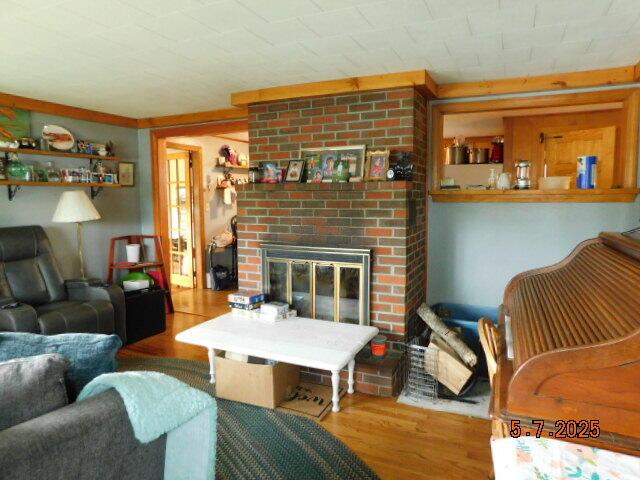 living area featuring wood finished floors and a fireplace