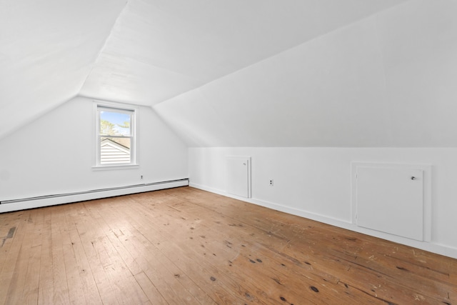 bonus room with baseboard heating, vaulted ceiling, and hardwood / wood-style floors