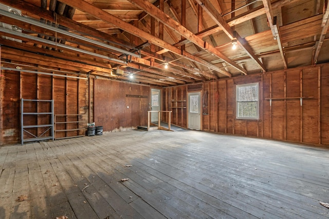 misc room with wood-type flooring and a garage