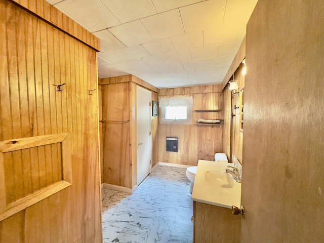 1429 Canada Rd, Moscow, ME 04920 - half bathroom with vanity, wood walls, and marble finish flooring