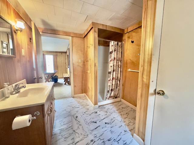 1429 Canada Rd, Moscow, ME 04920 - bathroom featuring wood walls, vanity, a stall shower, and marble look tiles