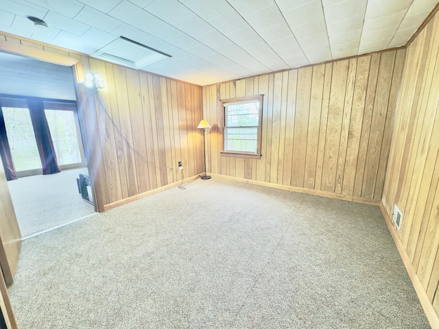 1429 Canada Rd, Moscow, ME 04920 - carpeted empty room with wood walls