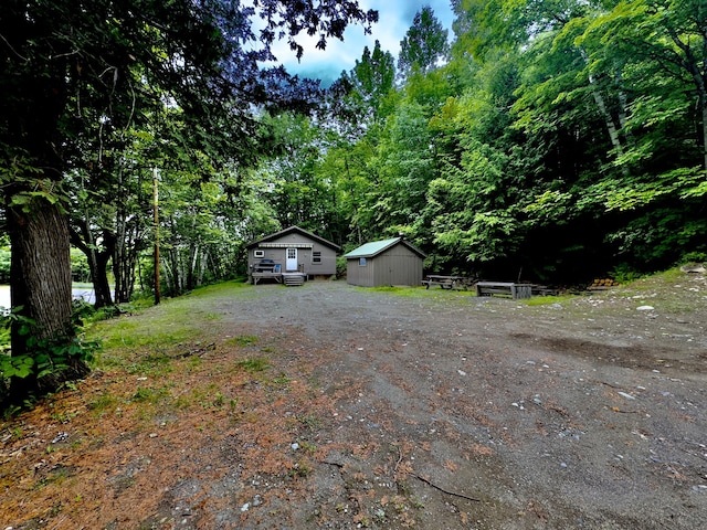 1429 Canada Rd, Moscow, ME 04920 - view of front of house featuring an outdoor structure and driveway