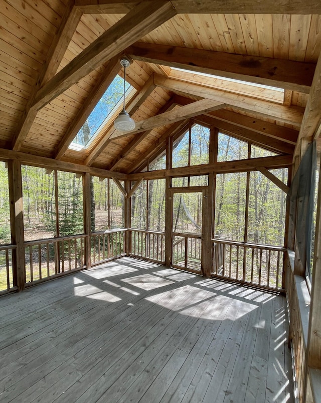 unfurnished sunroom with a skylight