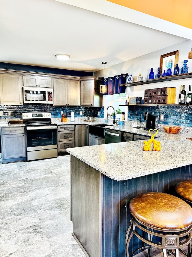 2 High St, Machias, ME 04654 - kitchen featuring stainless steel appliances, a sink, a peninsula, and tasteful backsplash