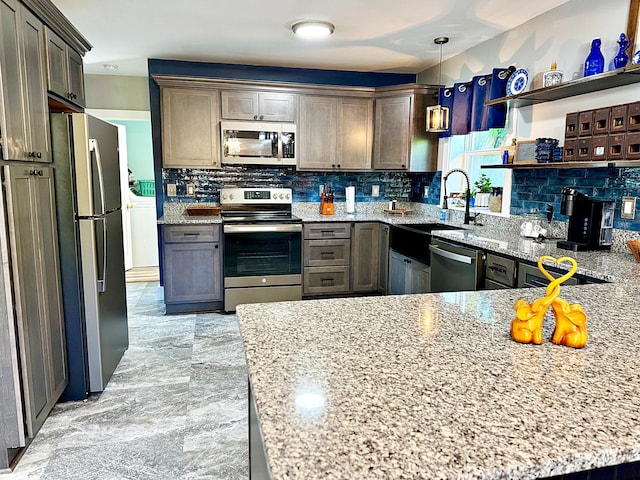 2 High St, Machias, ME 04654 - kitchen featuring stainless steel appliances, backsplash, light stone countertops, and light marble finish flooring