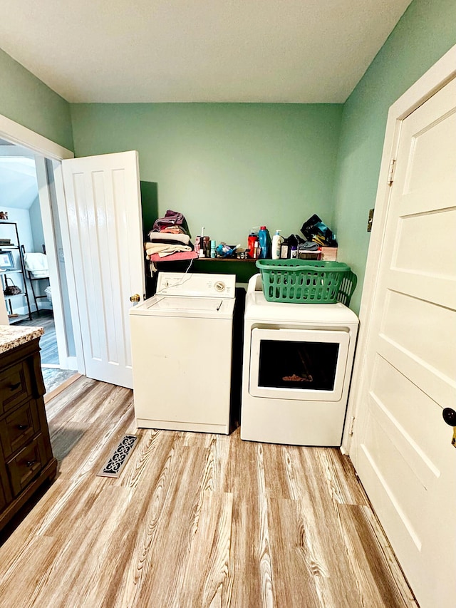 2 High St, Machias, ME 04654 - laundry area featuring washing machine and dryer and light wood-type flooring