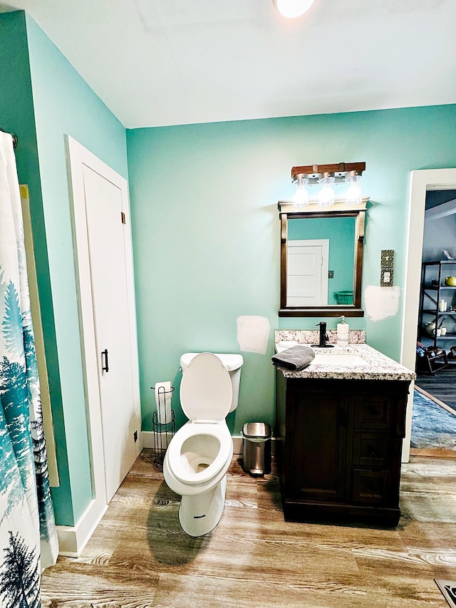 2 High St, Machias, ME 04654 - full bath with wood finished floors, vanity, and toilet