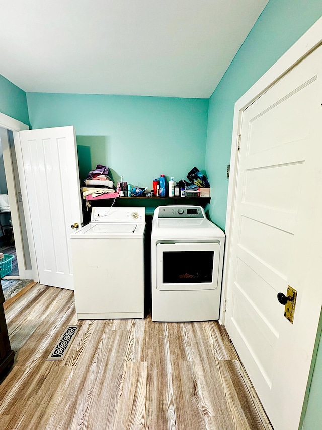 2 High St, Machias, ME 04654 - washroom with separate washer and dryer and light wood-style floors
