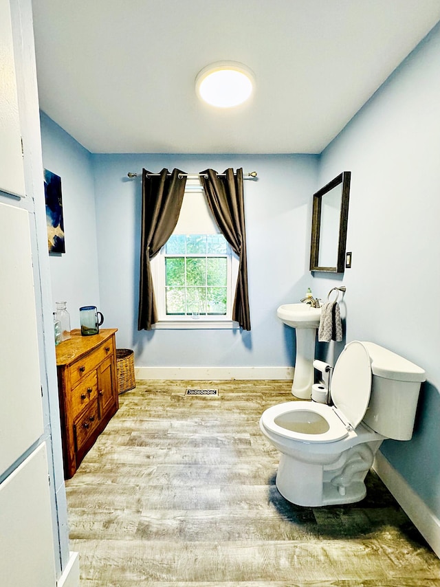 2 High St, Machias, ME 04654 - bathroom with baseboards, wood finished floors, and toilet