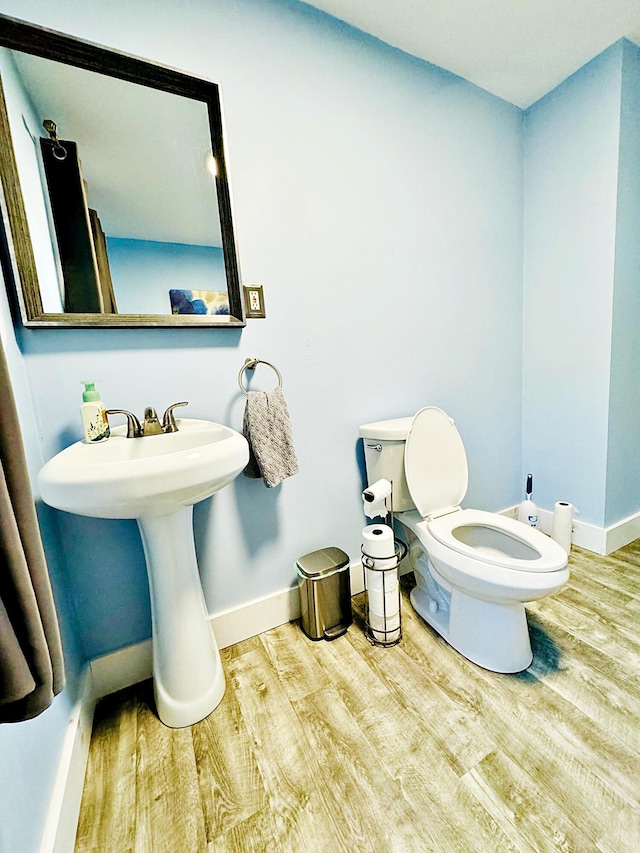 2 High St, Machias, ME 04654 - bathroom with wood finished floors, toilet, and baseboards