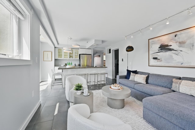 3027 Main St Unit 3027, Carrabassett Valley, ME 04947 - living area featuring baseboards, dark tile patterned floors, and track lighting