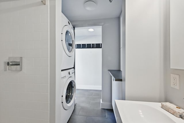 3027 Main St Unit 3027, Carrabassett Valley, ME 04947 - laundry room with estacked washer and dryer and dark tile patterned floors