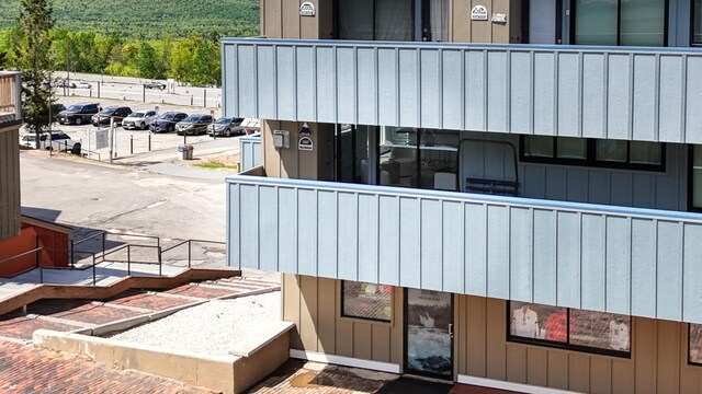 3027 Main St Unit 3027, Carrabassett Valley, ME 04947 - view of property featuring uncovered parking and a wooded view