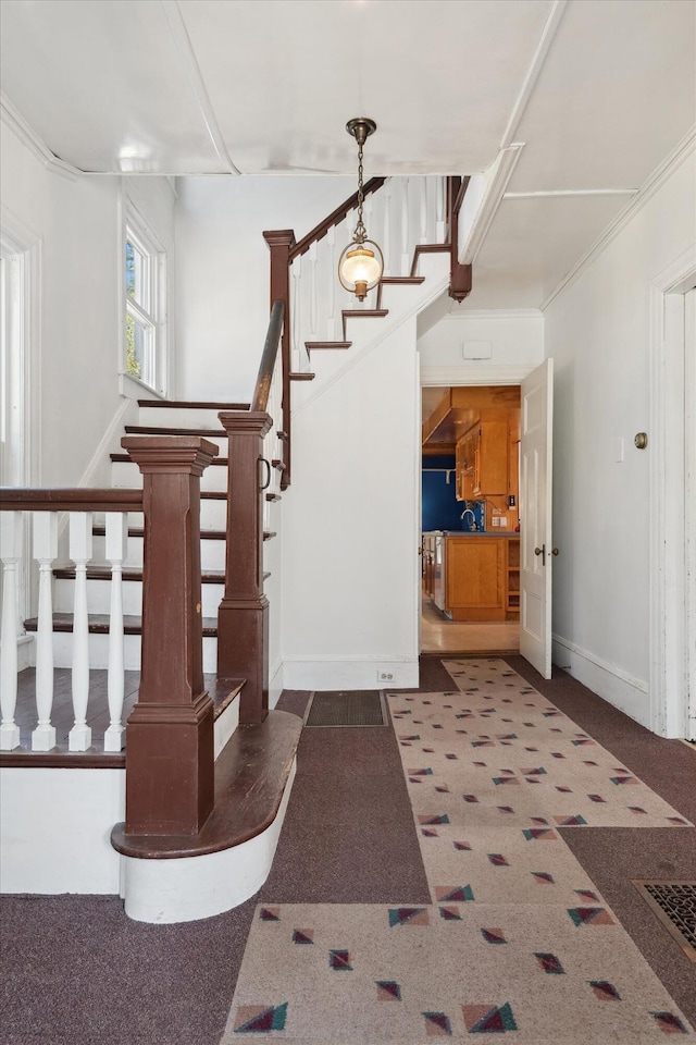 stairway with crown molding