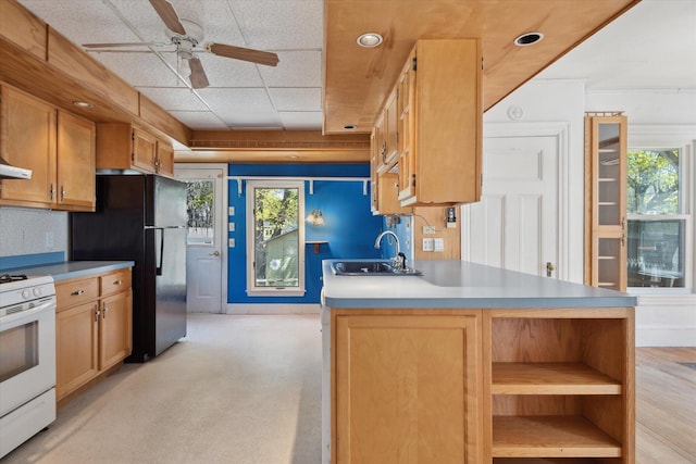 kitchen featuring a sink, white range, ceiling fan, open shelves, and light countertops