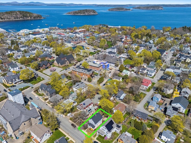 aerial view of property and surrounding area featuring property boundaries highlighted, a large body of water, and nearby suburban area