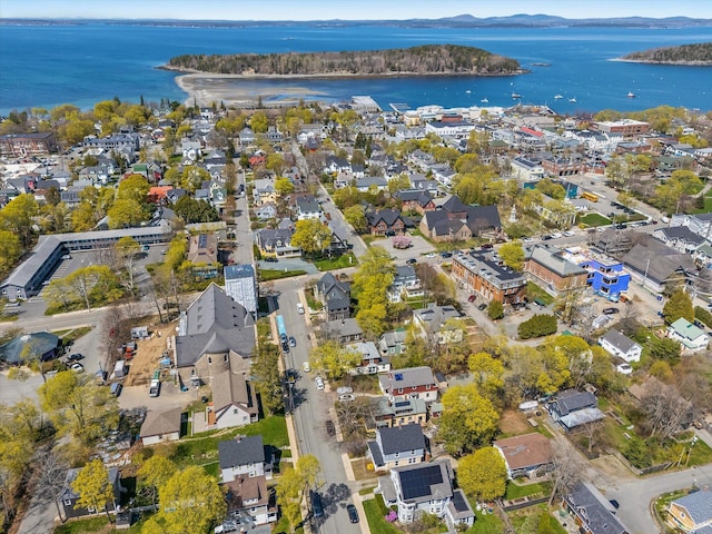aerial view of property and surrounding area featuring a water and mountain view